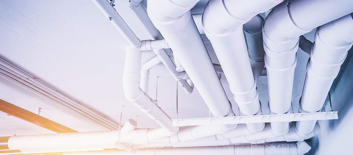 Large pipes for carrying water across the ceiling of a building.