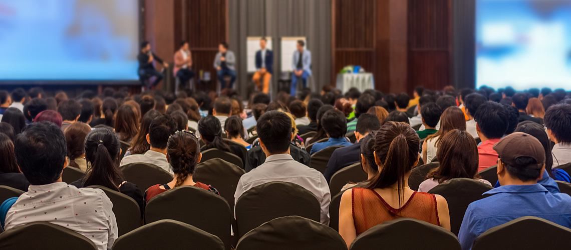 Crowd listening to a speaker at a water conference.