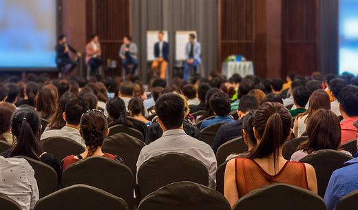 Crowd listening to a speaker at a water conference.