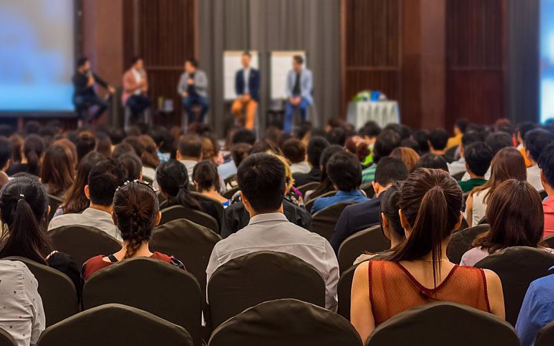 Crowd listening to a speaker at a water conference.