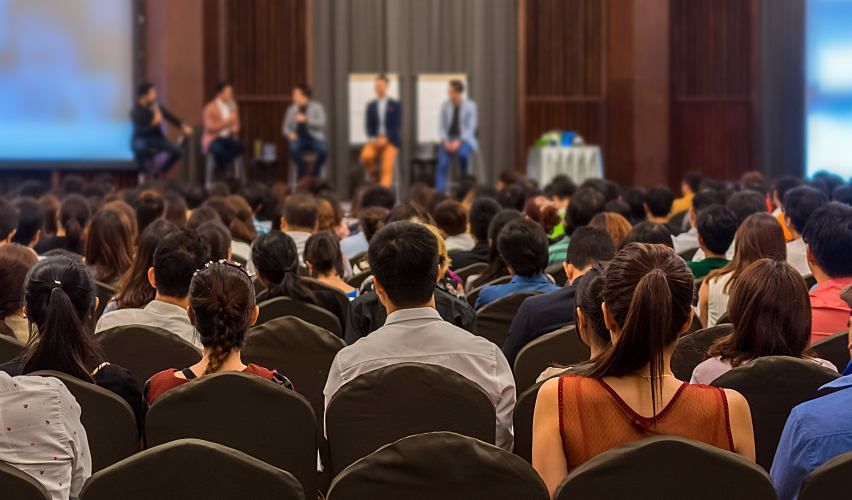 Crowd listening to a speaker at a water conference.