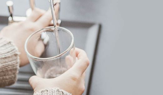 Woman pouring a glass of water.