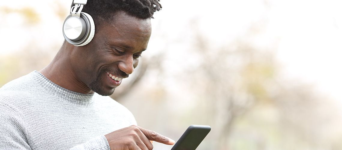 Man with headphones and a phone.