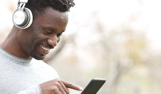 Man with headphones and a phone.