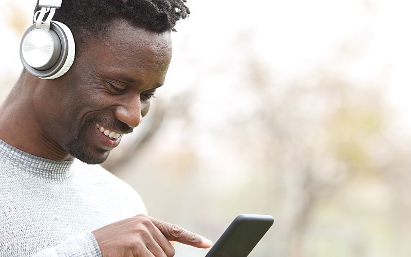 Man with headphones and a phone.