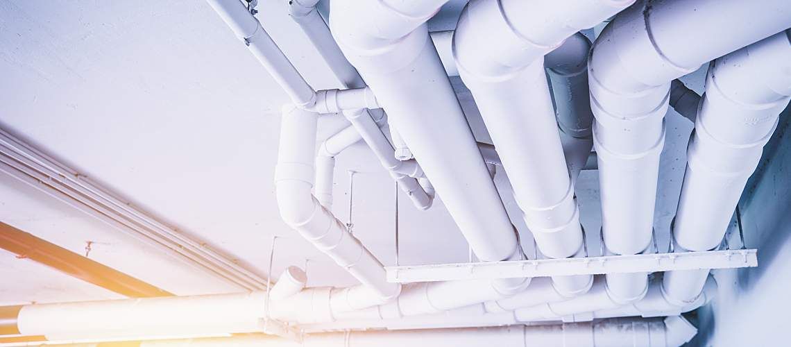 Large pipes for carrying water across the ceiling of a building.