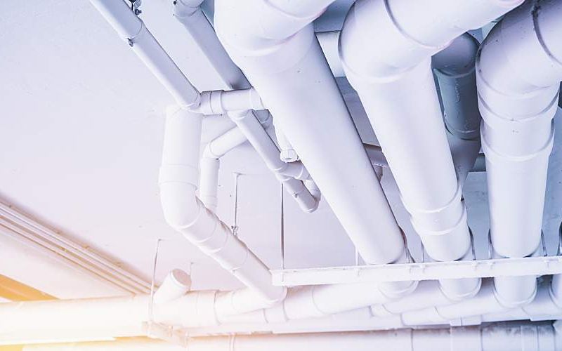 Large pipes for carrying water across the ceiling of a building.