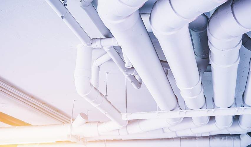 Large pipes for carrying water across the ceiling of a building.