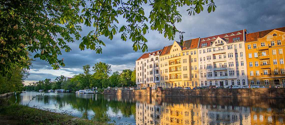 Apartments during sunset along the river near Berlin Castle Park.