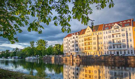 Apartments during sunset along the river near Berlin Castle Park.