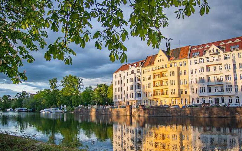 Apartments during sunset along the river near Berlin Castle Park.