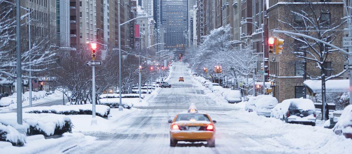 Cab driving down empty winter street in Manhattan.