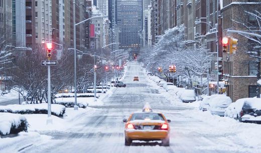 Cab driving down empty winter street in Manhattan.