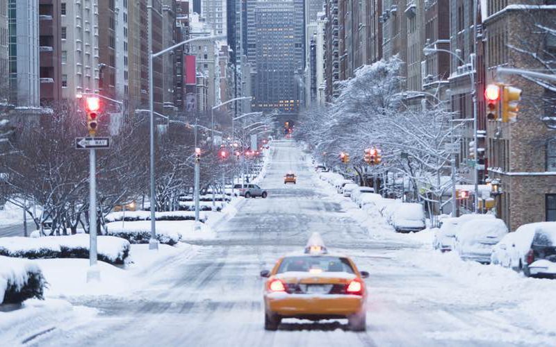 Cab driving down empty winter street in Manhattan.