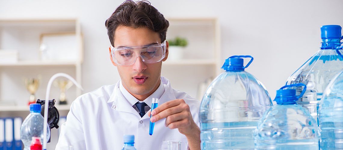 A lab tech tests samples of drinking water.