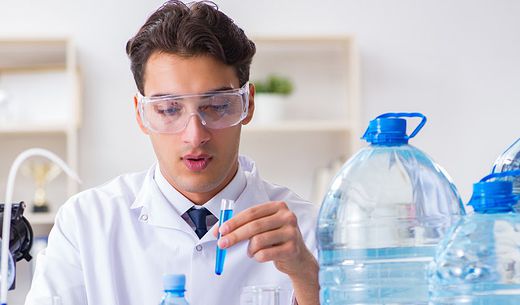 A lab tech tests samples of drinking water.