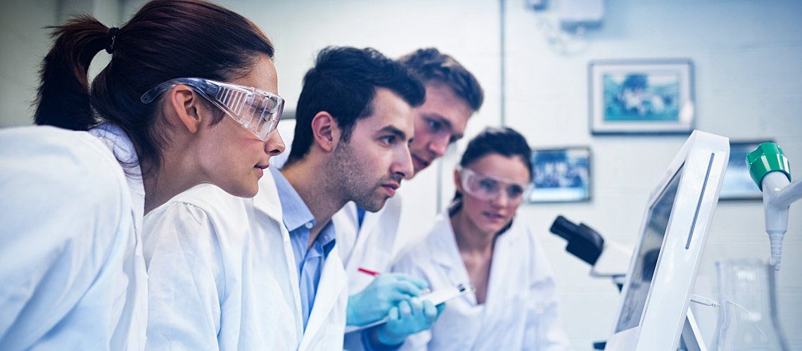 Laboratory technicians looking at test results.