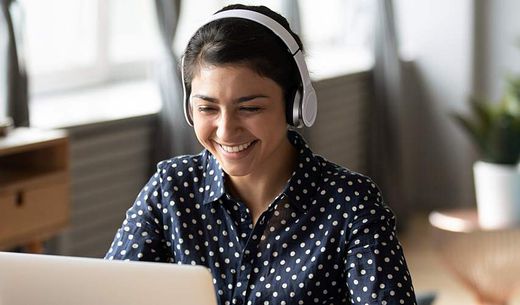 A woman attends a virtual conference