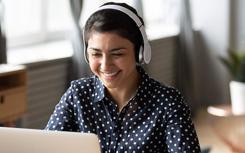 A woman attends a virtual conference