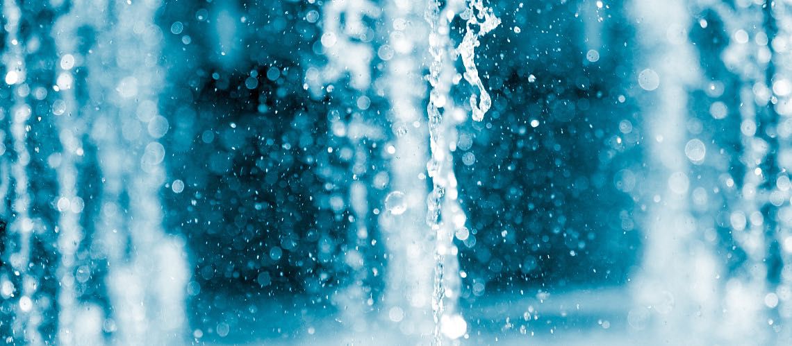 Closeup showing a gush from a water fountain.