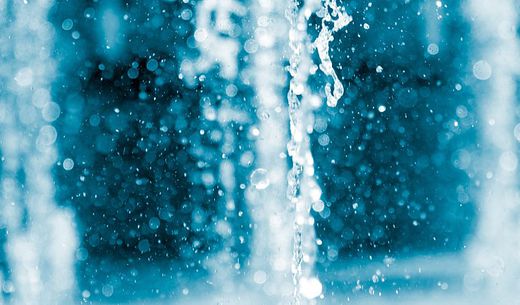 Closeup showing a gush from a water fountain.