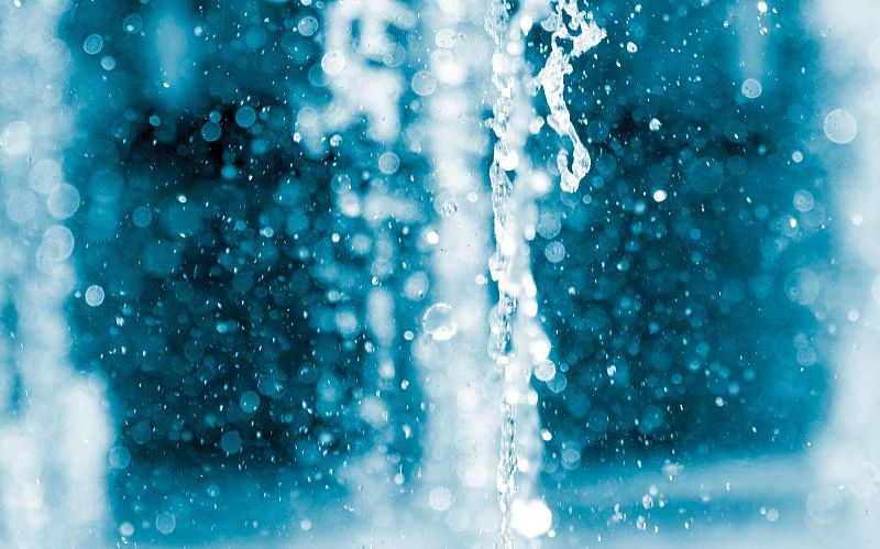 Closeup showing a gush from a water fountain.