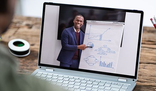 A man presents at a virtual conference.