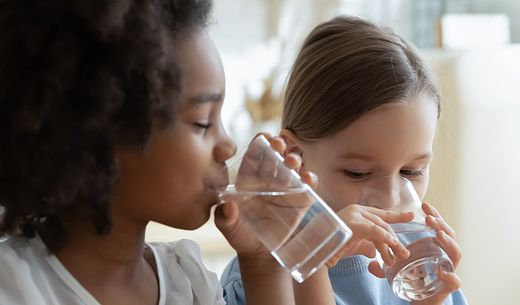 Two children drink water that meets the EPA water quality standards.