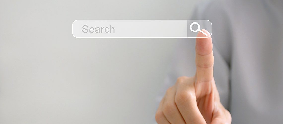 A person taps a search icon with their finger.