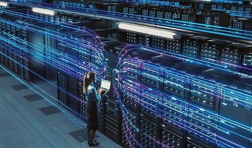 A technician stands in front of thirsty servers in data center.