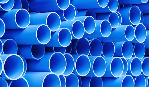 Stack of blue PVC pipes for drinking water