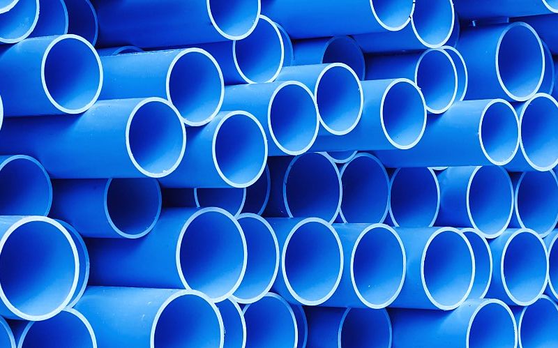 Stack of blue PVC pipes for drinking water