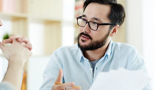 A manager talking to an employee in a water lab office.