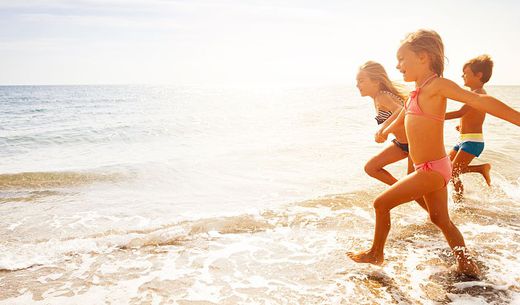 Children having fun at the beach on a sunny day.