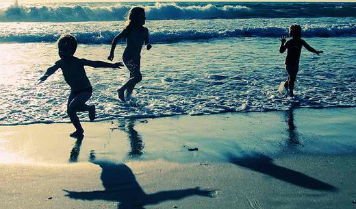 Children at beach at sunset.