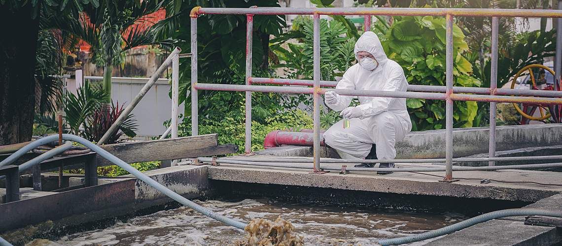 Scientist conducts wastewater sampling to detect pathogens for infectious diseases.