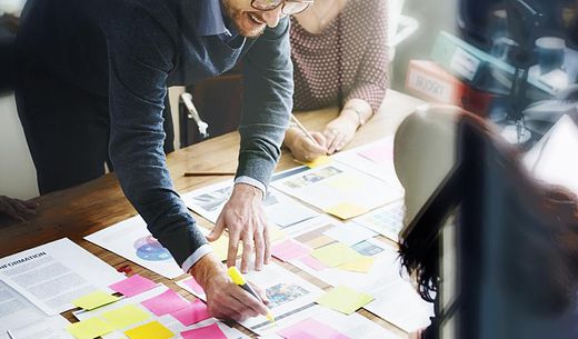 Employees creating a marketing plan in an office.