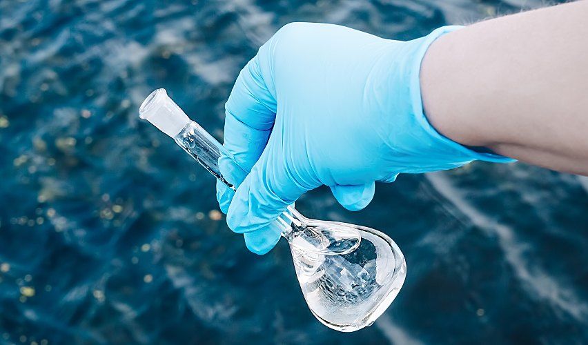 Test beaker with a water sample in it.
