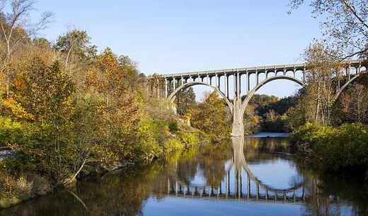 A bridge reflected in the Cuyahoga River in Ohio on an autumn day.