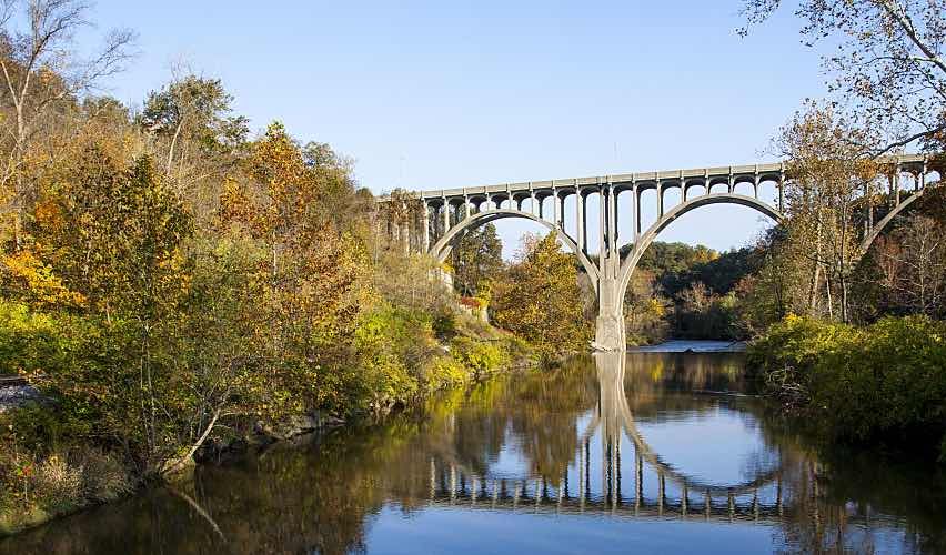 A bridge reflected in the Cuyahoga River in Ohio on an autumn day.