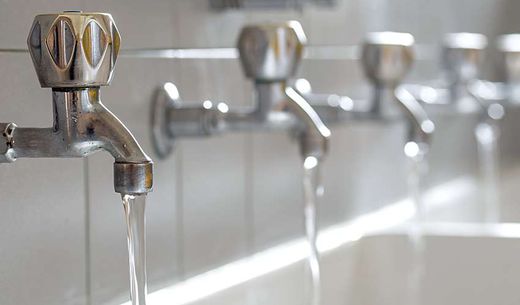 Line of public water faucet taps.