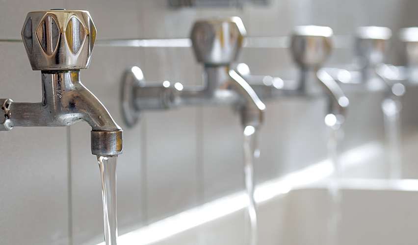 Line of public water faucet taps.