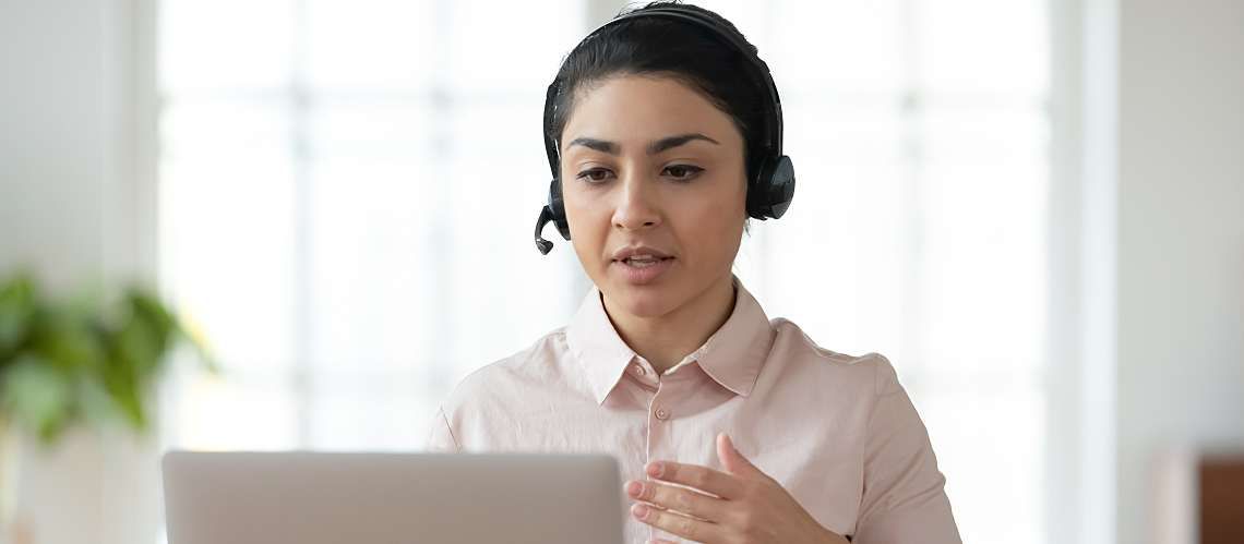 Person wearing a headset hosting a webinar from their home office.
