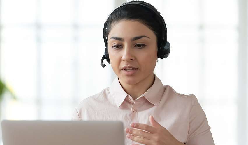 Person wearing a headset hosting a webinar from their home office.