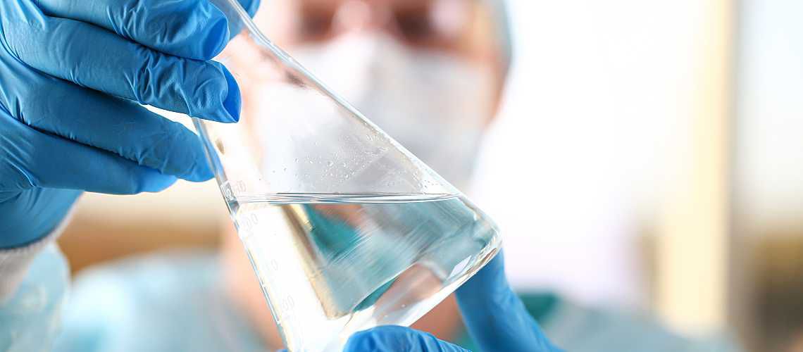 A scientist analyzes a surface water sample in a lab.