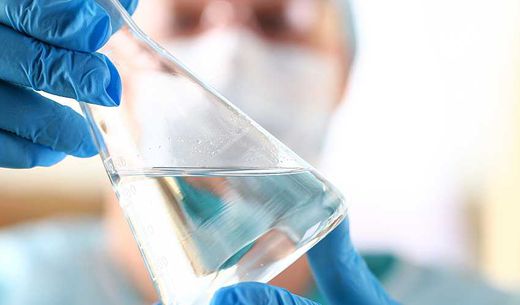 A scientist analyzes a surface water sample in a lab.