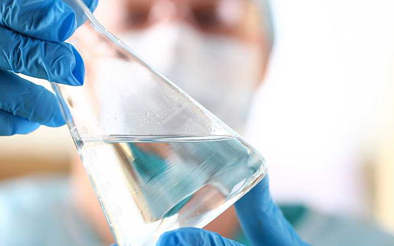 A scientist analyzes a surface water sample in a lab.