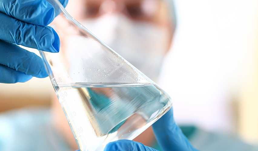 A scientist analyzes a surface water sample in a lab.