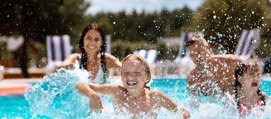 A family enjoys swimming in a clean pool treated with chlorine.