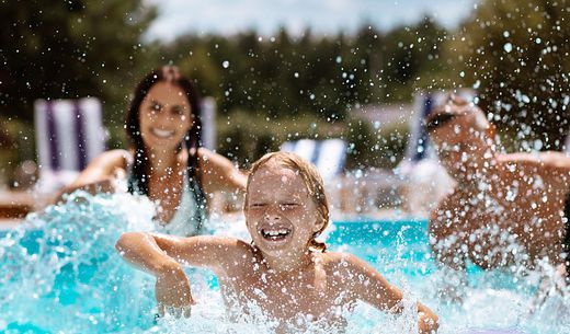 A family enjoys swimming in a clean pool treated with chlorine.